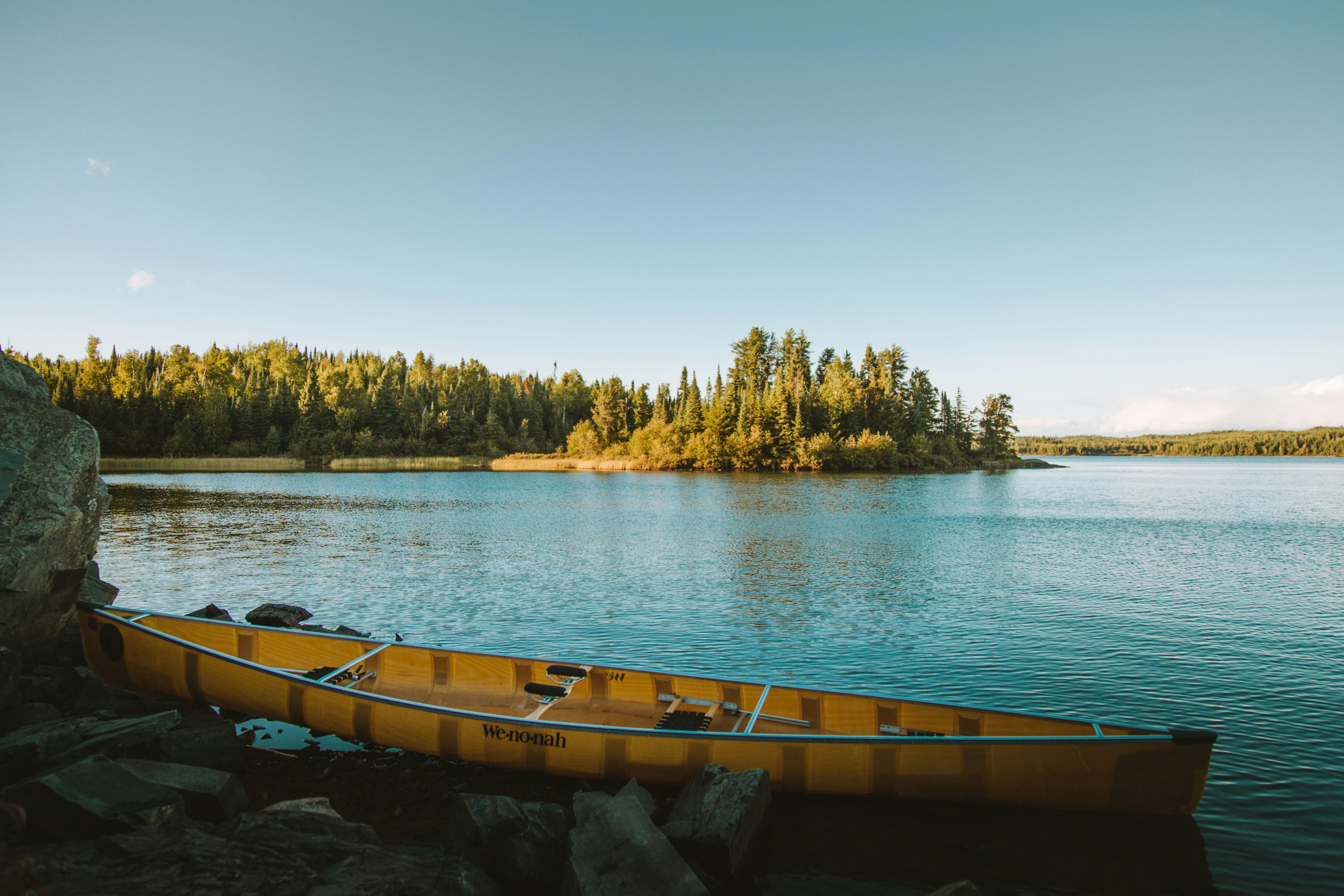 yellow canoe on body of water by Josh Hild courtesy of Unsplash.